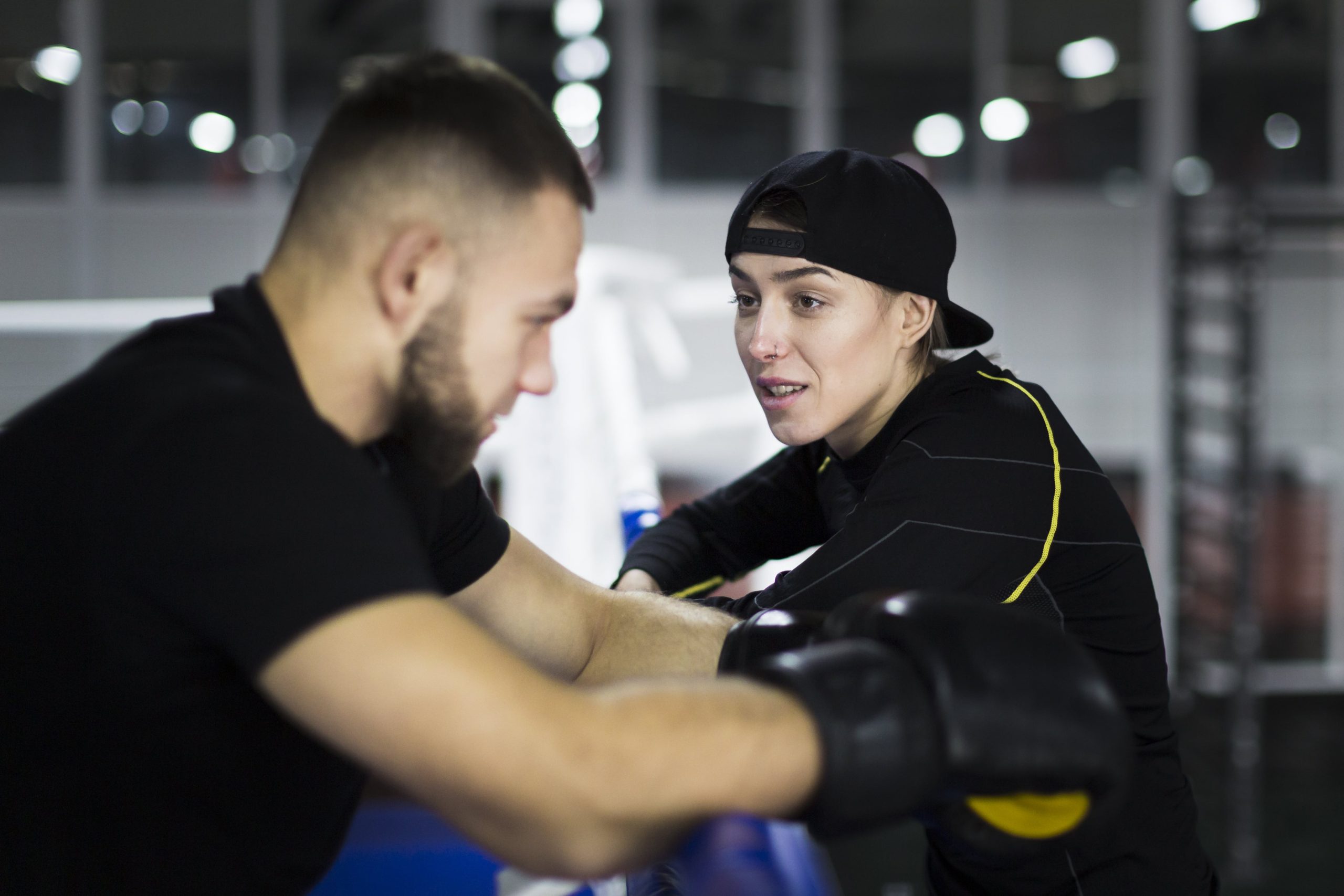 side-view-boxer-trainer-having-conversation-min side-view-boxer-trainer-having-conversation-min